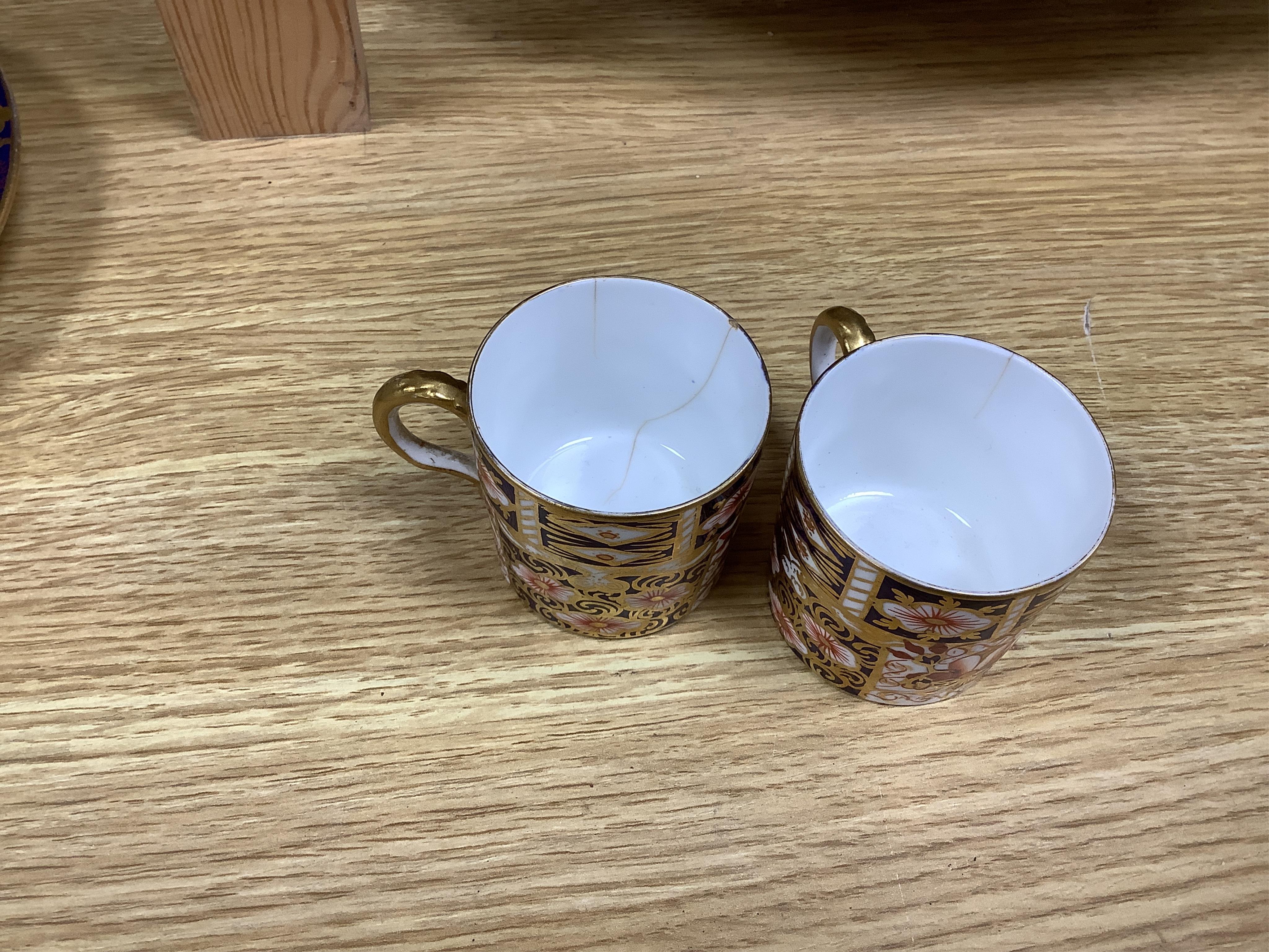 An English part teaset, c.1825 and six Royal Crown Derby coffee cans and saucers etc. Condition - some items cracked chipped and losses to gilding, teapot cover finial broken